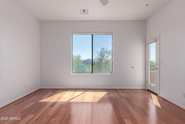 16600 N Thompson Peak Pkwy Unit 1072, Scottsdale, AZ 85260 - empty room with hardwood / wood-style floors, baseboards, ceiling fan, and visible vents