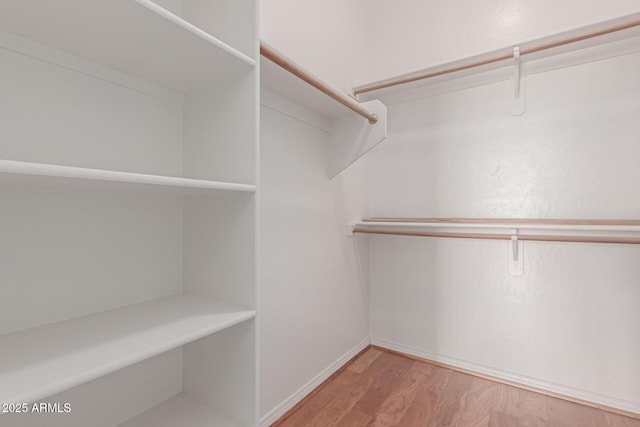 16600 N Thompson Peak Pkwy Unit 1072, Scottsdale, AZ 85260 - spacious closet featuring light wood finished floors