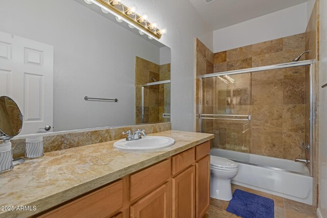 16600 N Thompson Peak Pkwy Unit 1072, Scottsdale, AZ 85260 - full bath with combined bath / shower with glass door, toilet, tile patterned floors, and vanity