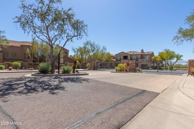 16600 N Thompson Peak Pkwy Unit 1072, Scottsdale, AZ 85260 - view of front of property with stucco siding, a gate, and fence