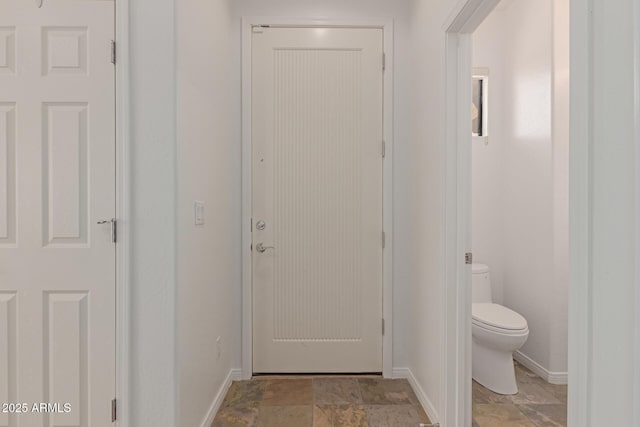 16600 N Thompson Peak Pkwy Unit 1072, Scottsdale, AZ 85260 - doorway with baseboards and stone finish flooring