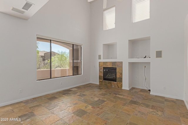 16600 N Thompson Peak Pkwy Unit 1072, Scottsdale, AZ 85260 - unfurnished living room featuring stone finish floor, baseboards, and a healthy amount of sunlight
