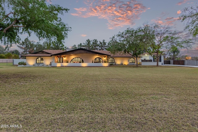 view of front of house with a front yard and fence