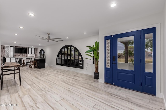 foyer featuring ceiling fan, light wood-style flooring, recessed lighting, and a wealth of natural light