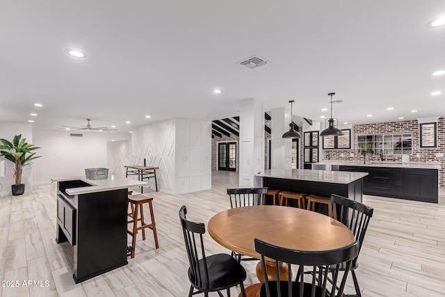 dining room featuring light wood finished floors, visible vents, recessed lighting, and a ceiling fan