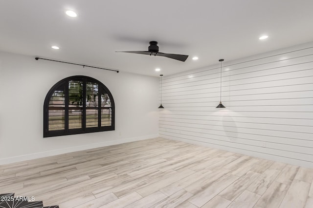 unfurnished room featuring a ceiling fan, recessed lighting, baseboards, and wood finished floors