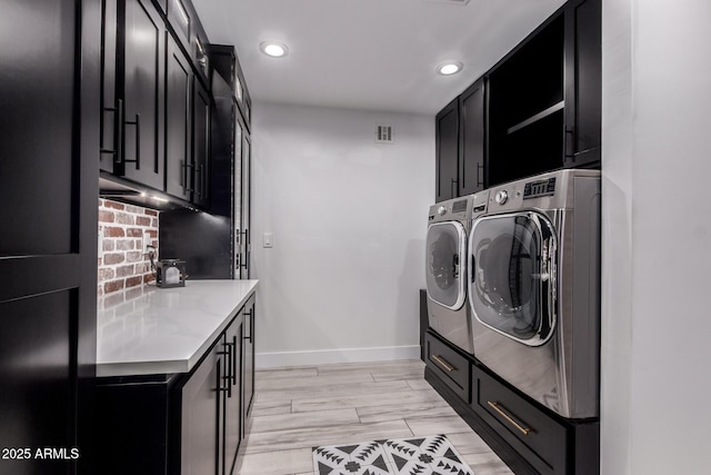clothes washing area featuring recessed lighting, baseboards, separate washer and dryer, visible vents, and cabinet space