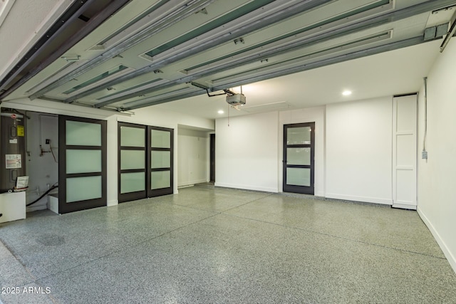 garage with baseboards, electric water heater, and a garage door opener