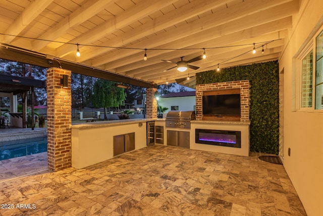view of patio with exterior kitchen, a grill, and ceiling fan