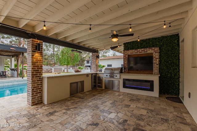 view of patio featuring a grill, an outdoor pool, exterior kitchen, and a ceiling fan