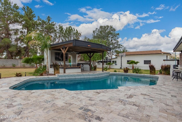 pool with a gazebo, fence, and a patio area