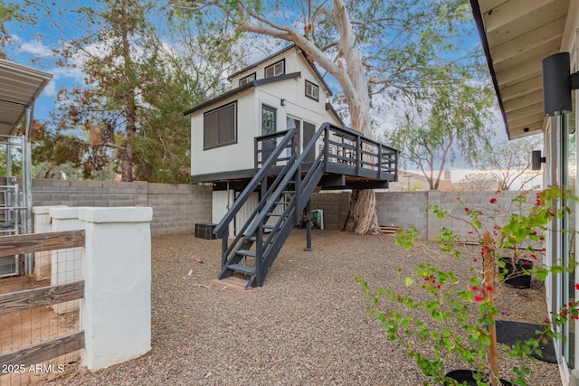 exterior space with a fenced backyard, stairs, and a deck