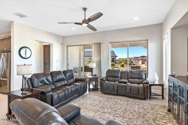 living area with a ceiling fan, recessed lighting, and visible vents