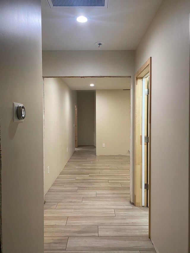 corridor with light wood-type flooring