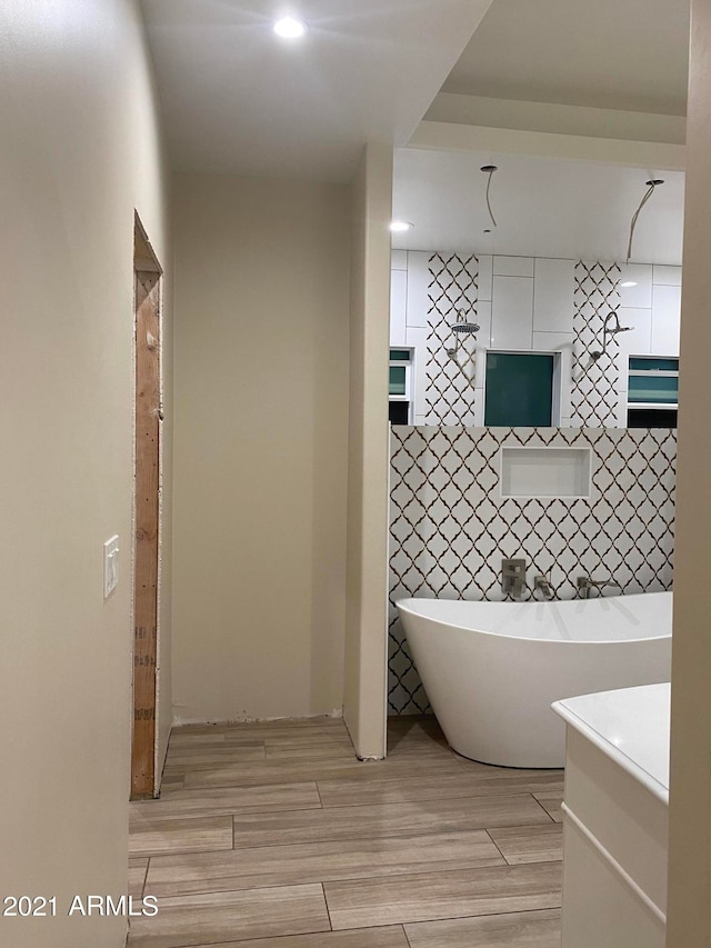 bathroom featuring tile flooring, tile walls, and vanity