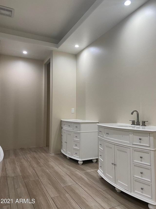 bathroom with vanity and hardwood / wood-style floors