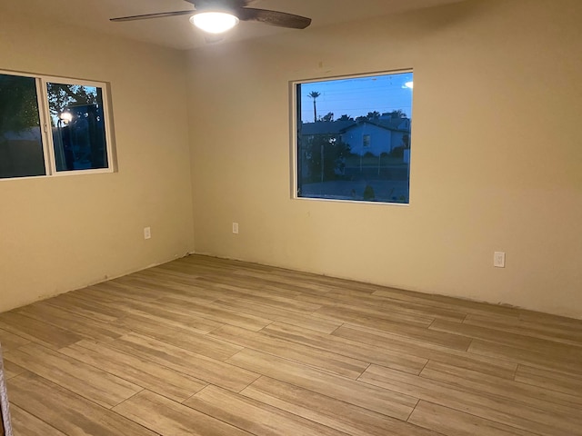 unfurnished room featuring light hardwood / wood-style floors and ceiling fan