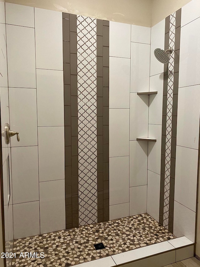 bathroom with a tile shower