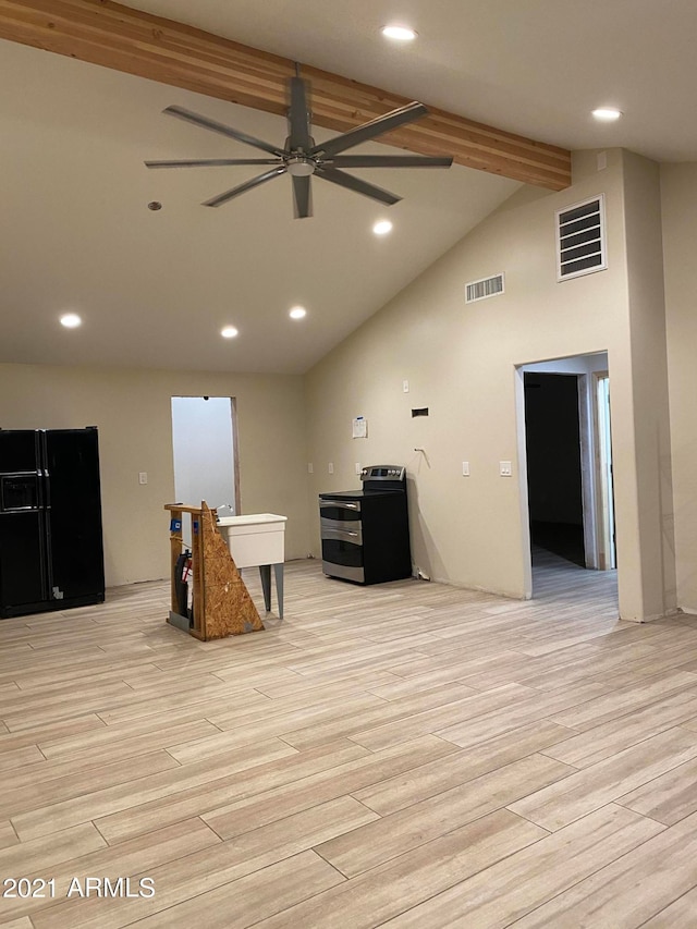 sitting room featuring beamed ceiling, light hardwood / wood-style floors, and ceiling fan