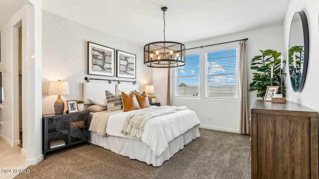 bedroom with carpet floors and a notable chandelier