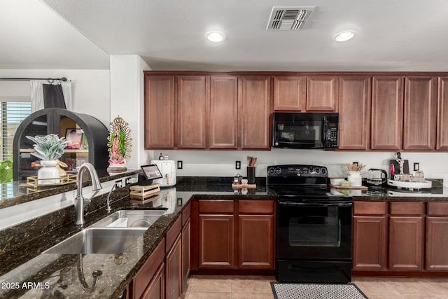 2223 S Hughes Dr, Buckeye, AZ 85326 - kitchen with black appliances, a sink, dark stone countertops, light tile patterned floors, and recessed lighting