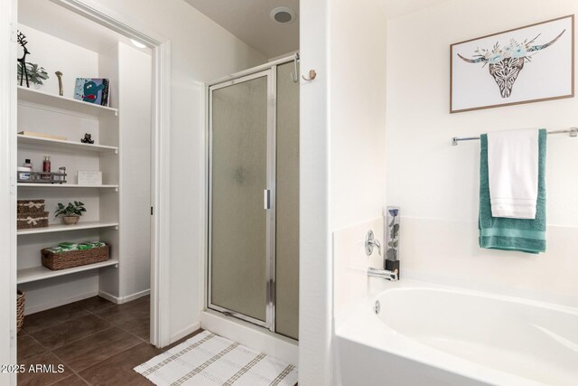 2223 S Hughes Dr, Buckeye, AZ 85326 - bathroom with a shower stall, a garden tub, and tile patterned flooring