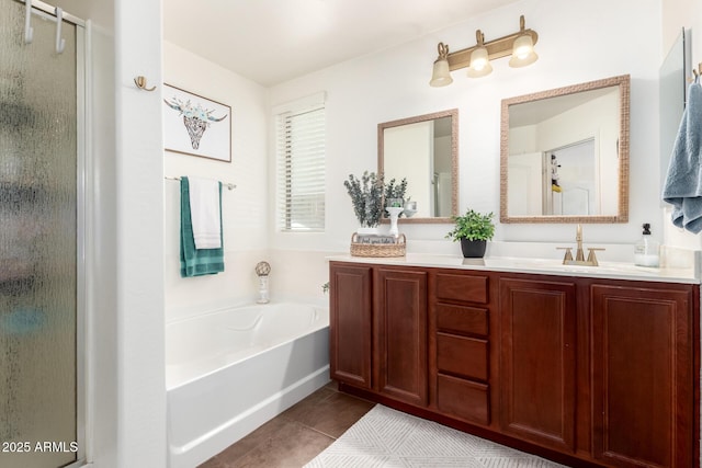 2223 S Hughes Dr, Buckeye, AZ 85326 - bathroom featuring a shower stall, tile patterned floors, double vanity, and a garden tub