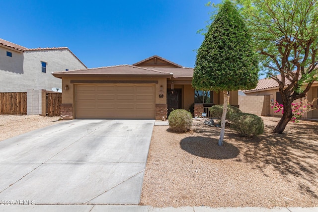 2223 S Hughes Dr, Buckeye, AZ 85326 - view of front of house with a garage, driveway, a tiled roof, stucco siding, and stone siding