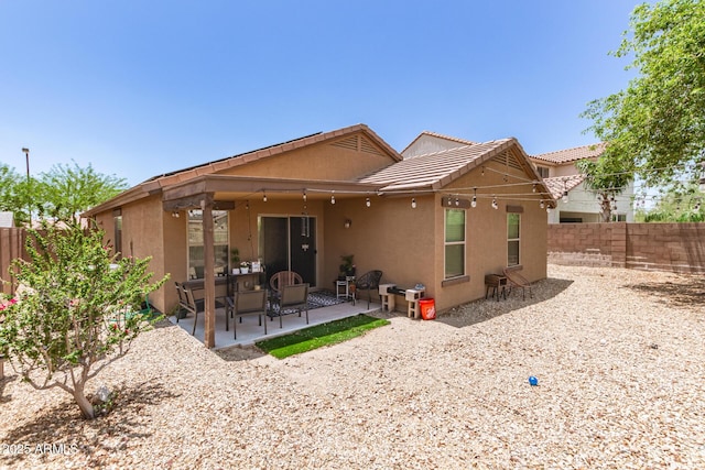 2223 S Hughes Dr, Buckeye, AZ 85326 - back of house with stucco siding, a fenced backyard, a patio area, and a tile roof
