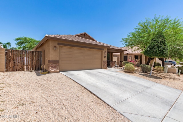 2223 S Hughes Dr, Buckeye, AZ 85326 - single story home featuring a tile roof, concrete driveway, an attached garage, stucco siding, and a gate