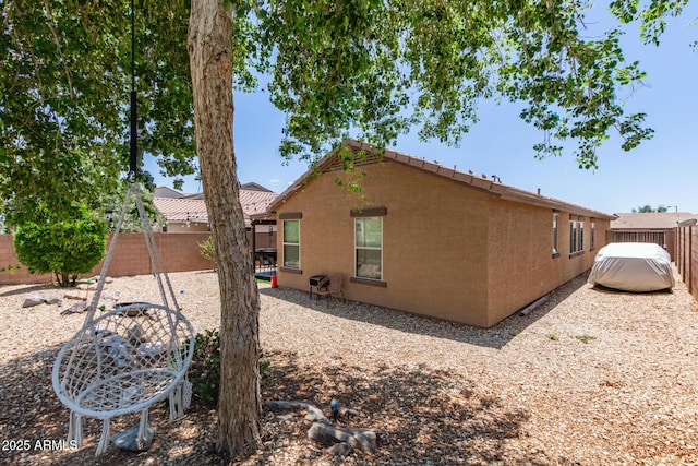 2223 S Hughes Dr, Buckeye, AZ 85326 - view of side of home with a fenced backyard, stucco siding, and a tile roof