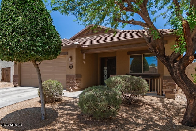 2223 S Hughes Dr, Buckeye, AZ 85326 - ranch-style home with stone siding, concrete driveway, a tile roof, a garage, and stucco siding