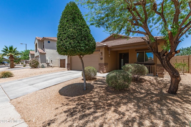 2223 S Hughes Dr, Buckeye, AZ 85326 - view of front of property with stucco siding, a tile roof, concrete driveway, and an attached garage