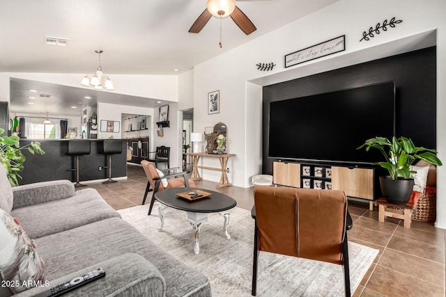 2223 S Hughes Dr, Buckeye, AZ 85326 - living room featuring tile patterned floors, a chandelier, a ceiling fan, and vaulted ceiling