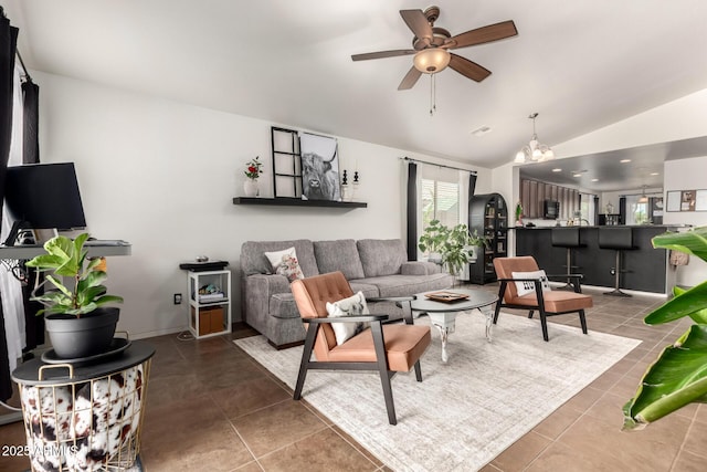 2223 S Hughes Dr, Buckeye, AZ 85326 - tiled living room featuring lofted ceiling, a ceiling fan, and a chandelier
