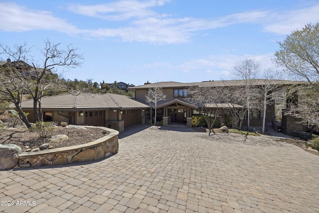 view of front facade with a garage and decorative driveway