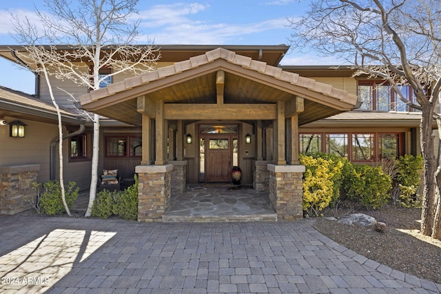 view of exterior entry featuring a porch