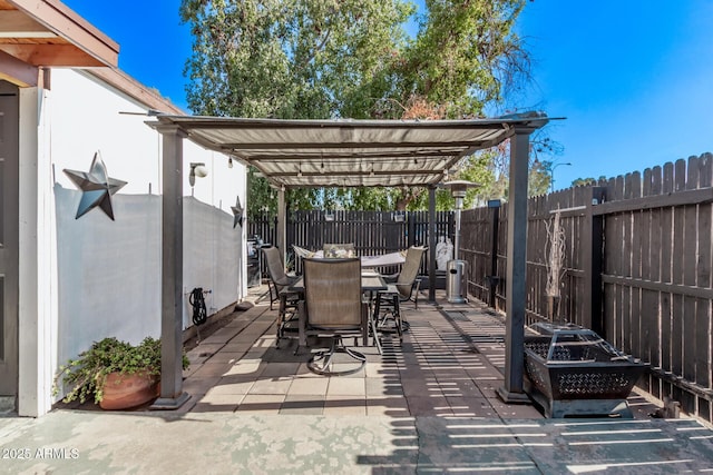 view of patio / terrace featuring outdoor dining space, an outdoor fire pit, a fenced backyard, and a pergola