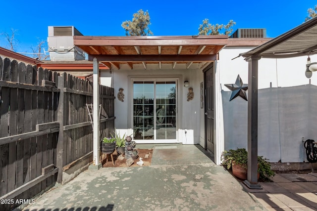 view of patio with central AC unit and fence