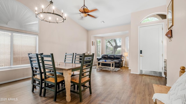 dining room with plenty of natural light, vaulted ceiling, wood finished floors, and a ceiling fan