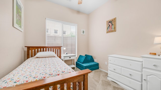 bedroom featuring light carpet, baseboards, and a ceiling fan