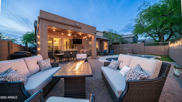 view of patio / terrace featuring an outdoor living space with a fire pit, outdoor dining area, and a fenced backyard