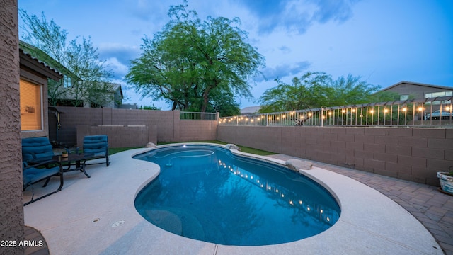 view of swimming pool with a fenced backyard and a patio area