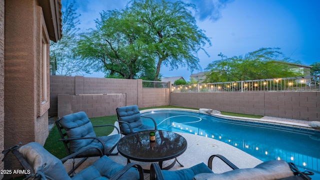 view of pool with a fenced backyard