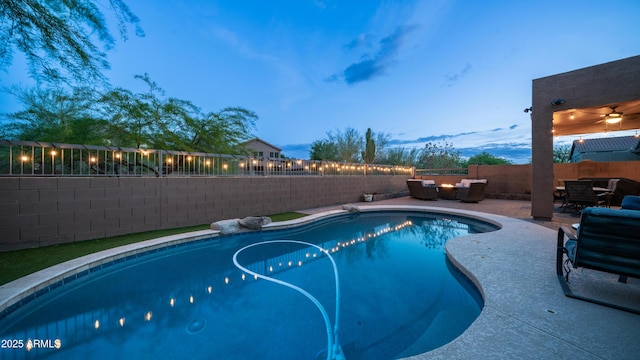pool at dusk with a fenced backyard, an outdoor hangout area, and a patio