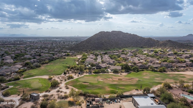 aerial view of residential area featuring a mountainous background and a golf club