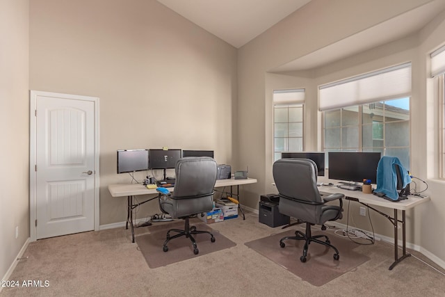 office space featuring light colored carpet and lofted ceiling