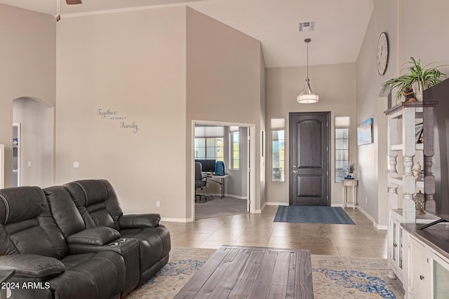 entryway featuring tile patterned floors and a high ceiling