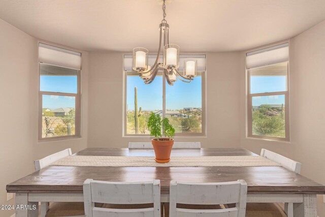 unfurnished dining area with a chandelier and plenty of natural light