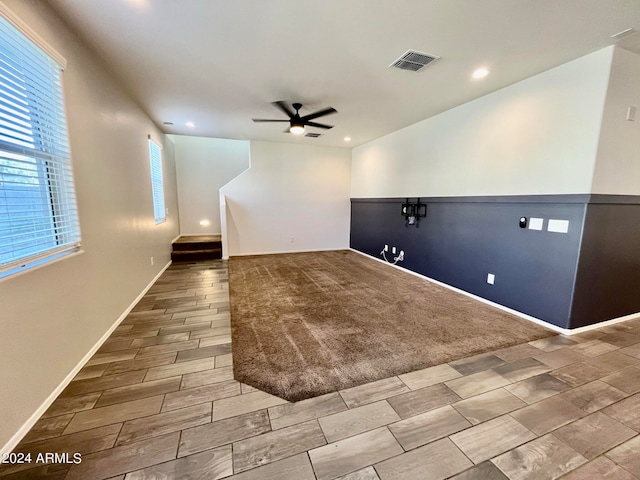 empty room with carpet floors and ceiling fan